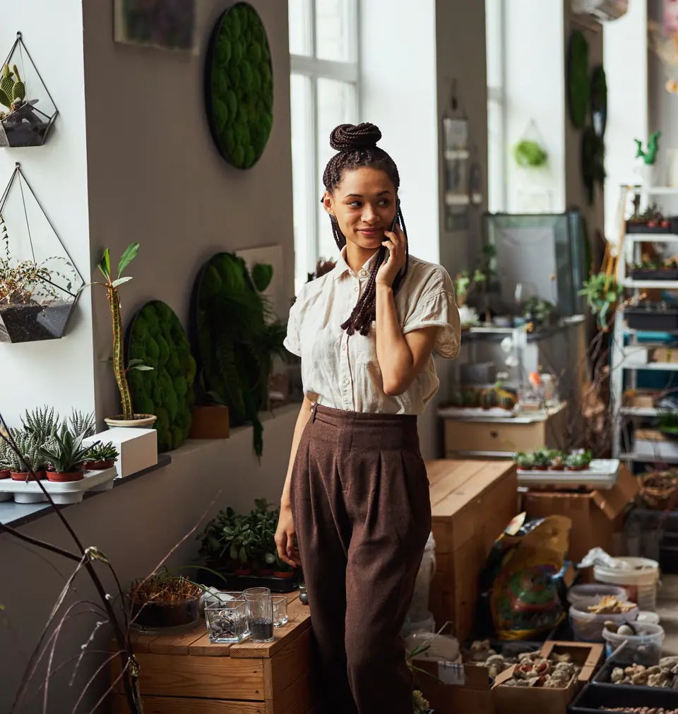 Small business owner taking a phone call in her flower shop